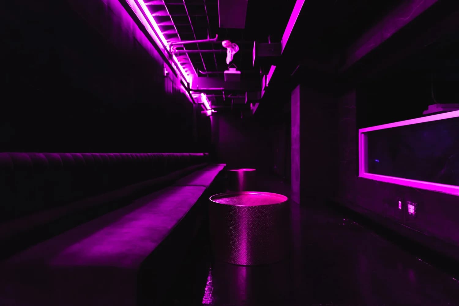 Neon-lit lounge corridor at Eden, New York City