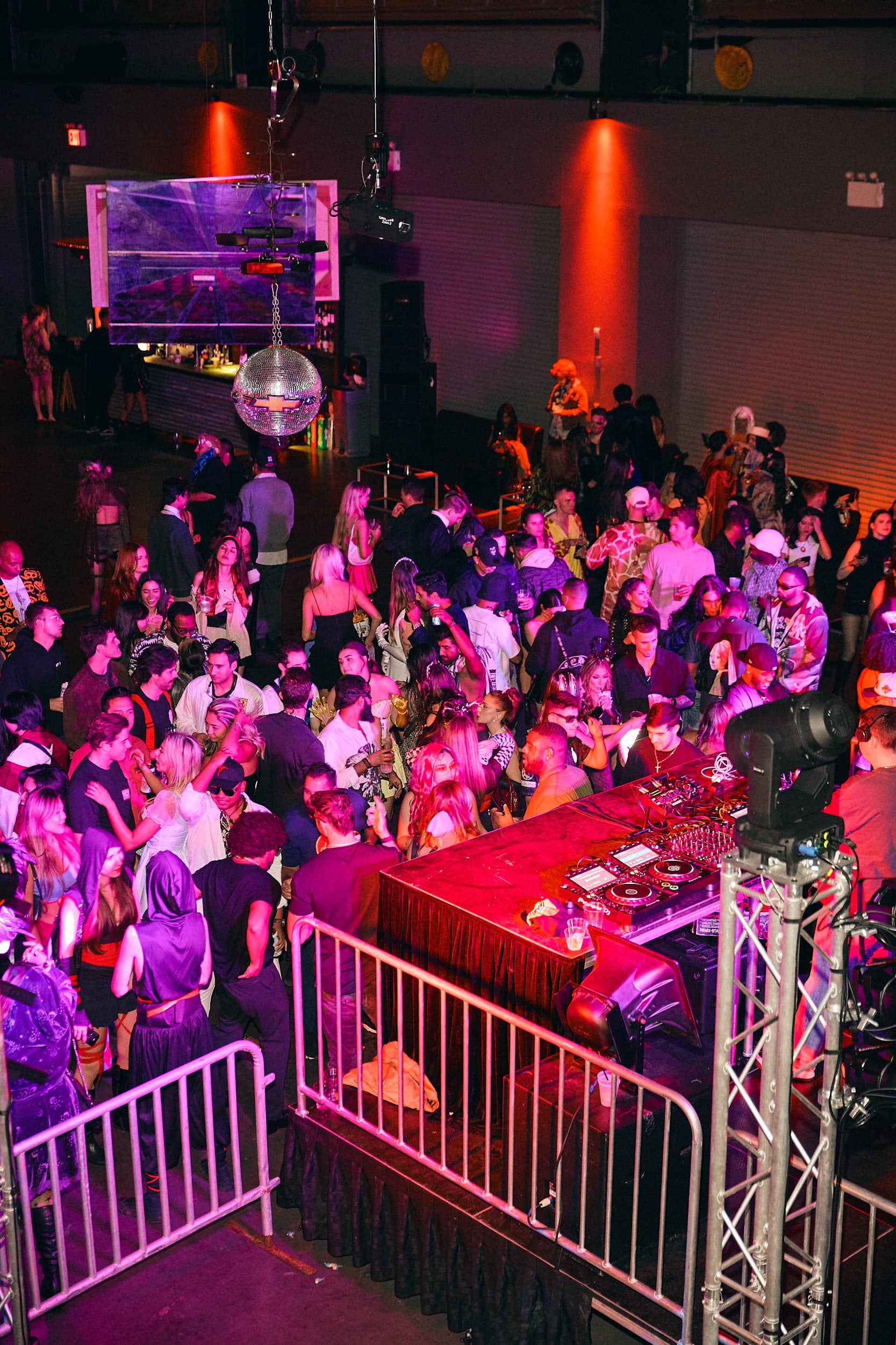 Crowd and DJ booth at a Halloween NYC nightlife event